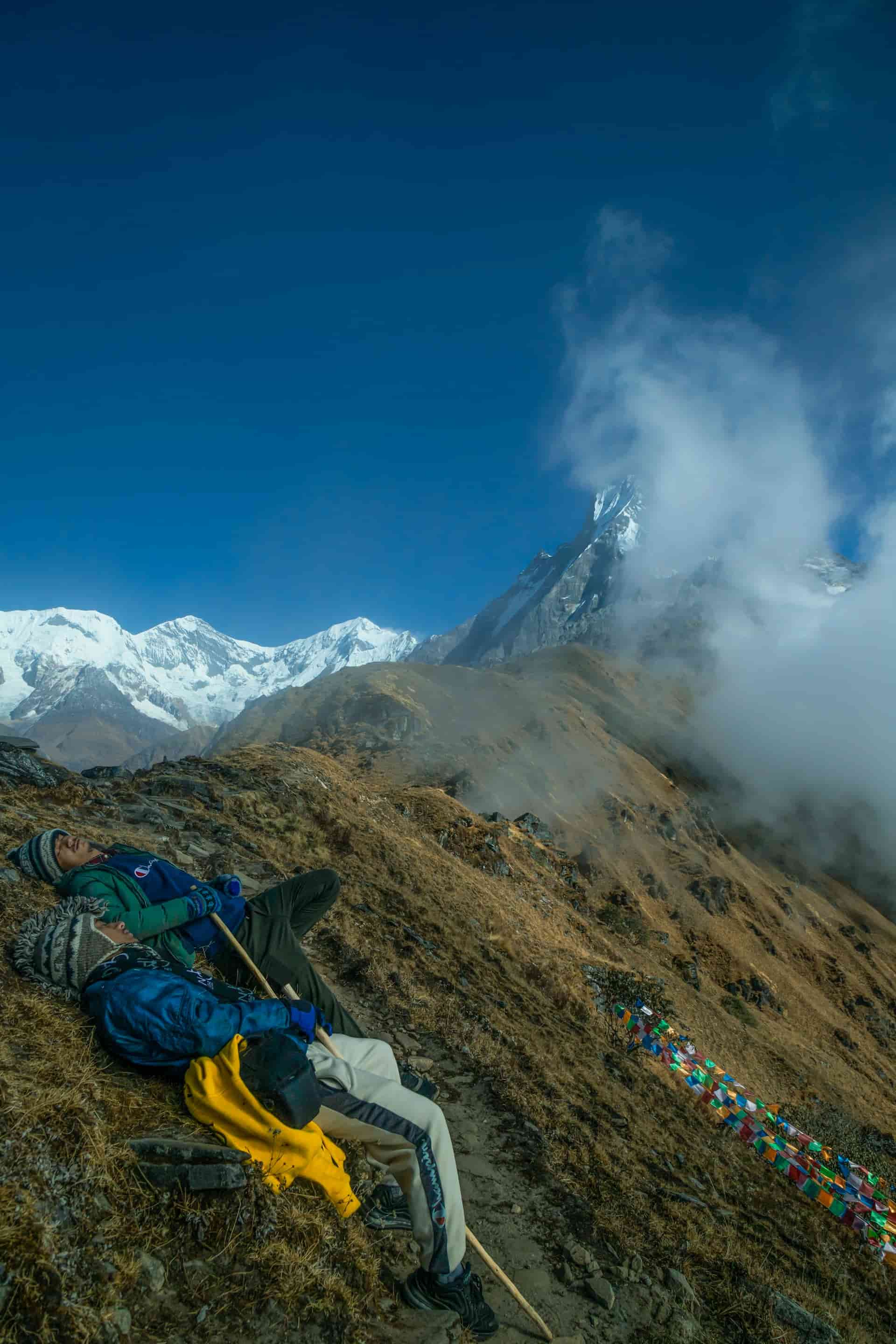 Two Trekkers Resting Under the Himalayan Sky on the Mardi Himal Trek